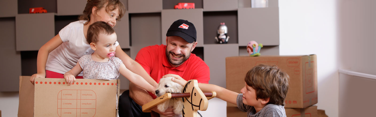 AGS Movers staff member petting dog with kids.