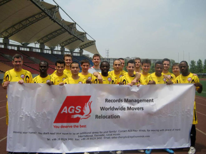 Football team holding a AGS Mover banner